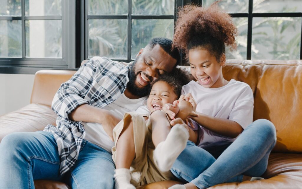 Happy family playing on couch