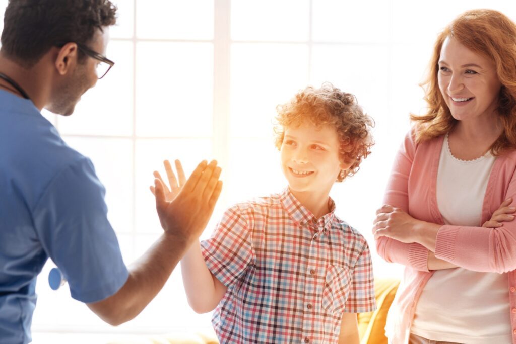 doctor high fiving kid